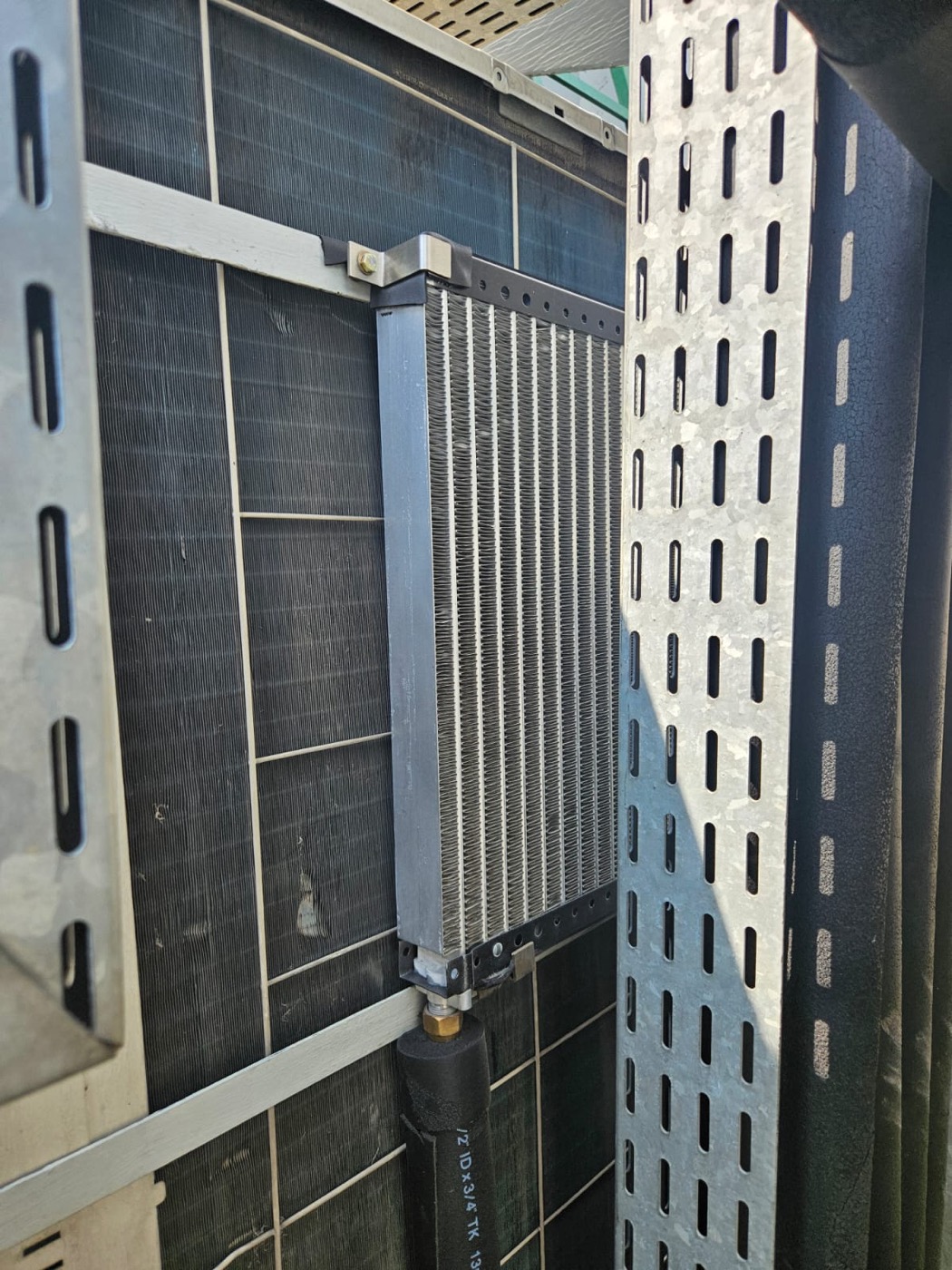 ESP heat-exchange panel fitted to the condenser front at this site